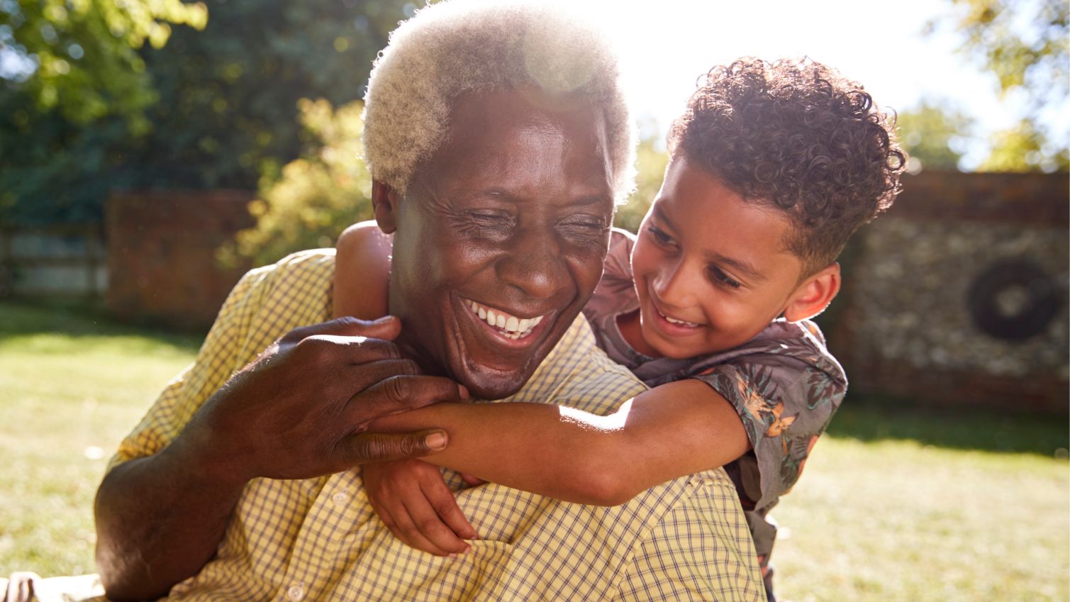 Grandfather and grandson hug outside